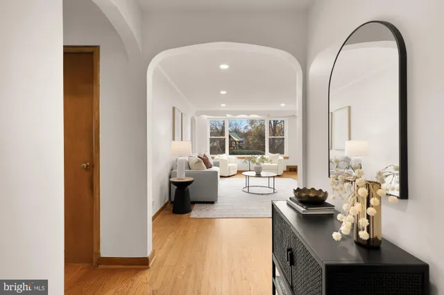 a living room with fireplace furniture and a large window