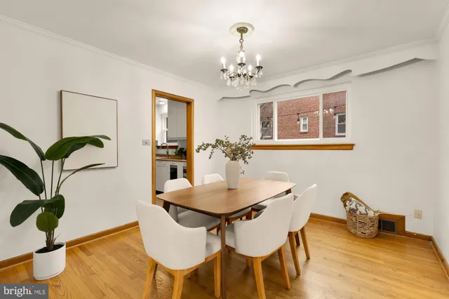 a view of a dining room with furniture wooden floor and chandelier