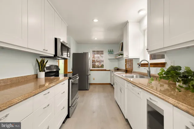 a kitchen with a refrigerator and a window