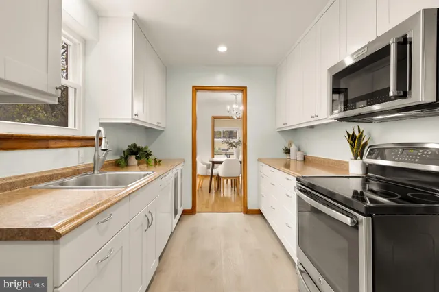 a bathroom with a sink mirror and toilet