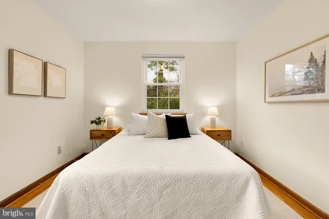 a bedroom with a bed and a lamp