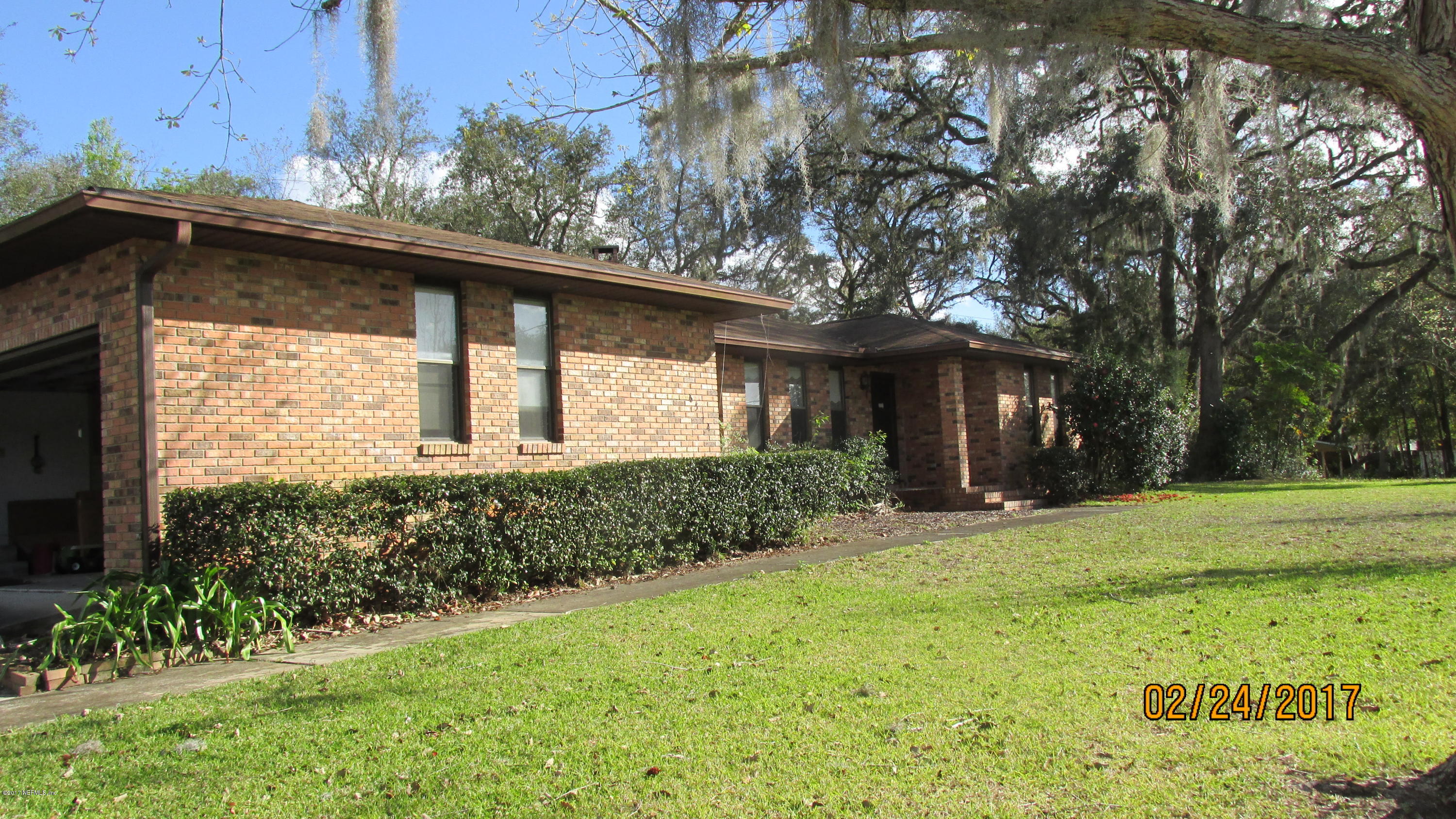 6514 Immokalee Road Keystone Heights, FL 32656 - Photo 1 of 10 a front view of a house with garden