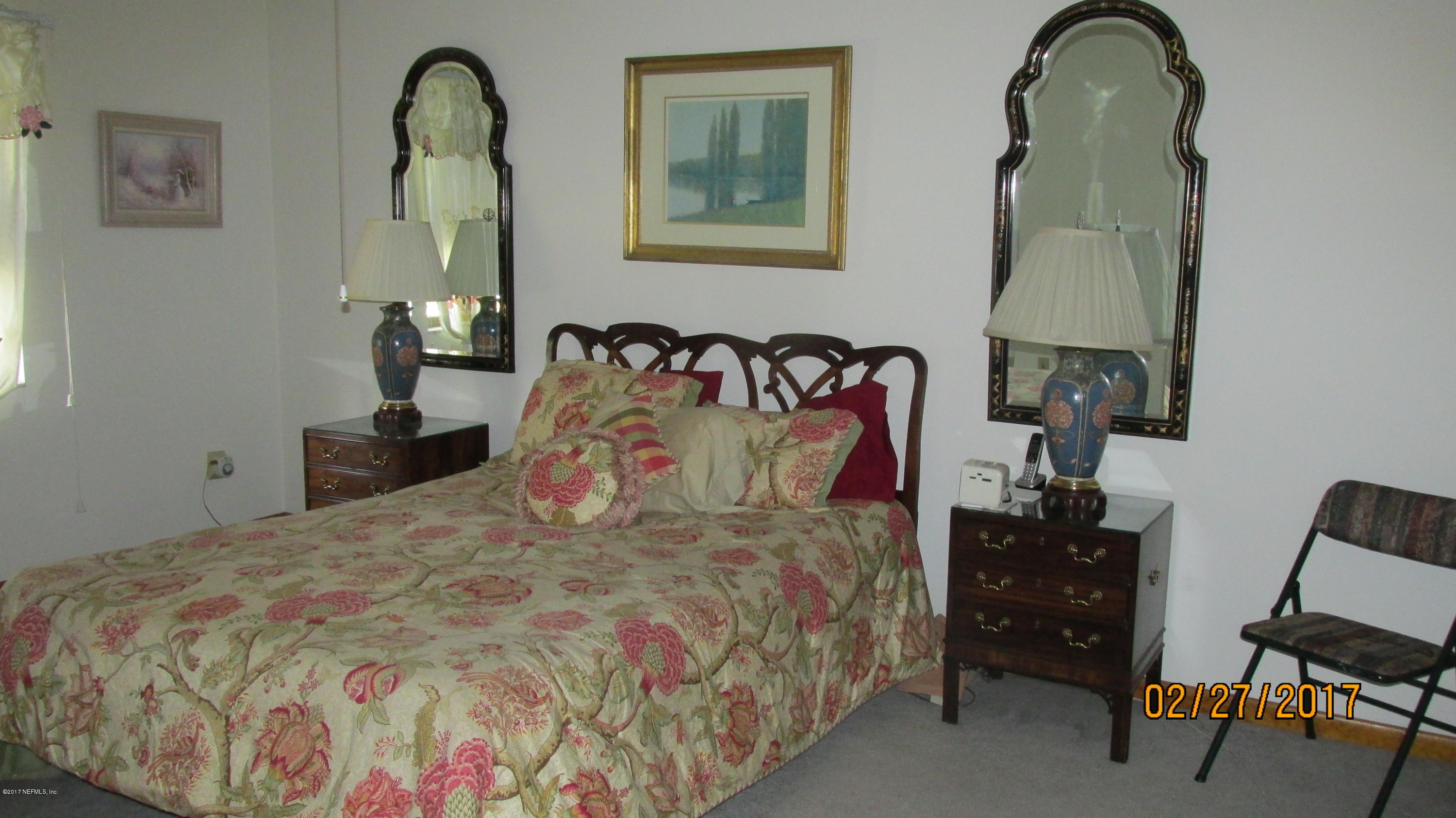 6514 Immokalee Road Keystone Heights, FL 32656 - Photo 8 of 10 a bedroom with a bed and a painting on the wall