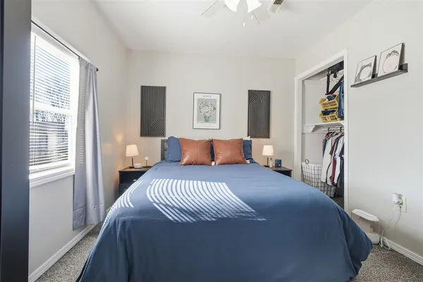 a bedroom with a large bed and a window