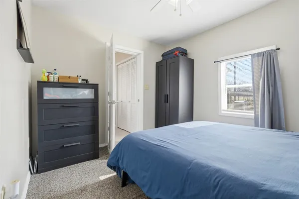 a bedroom with a bed and a closet