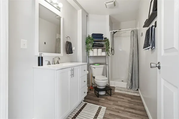 a bathroom with a sink toilet and shower
