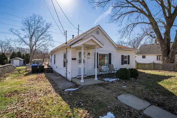 a view of a house with a yard covered in snow