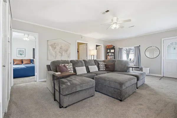 a living room with furniture and a large mirror