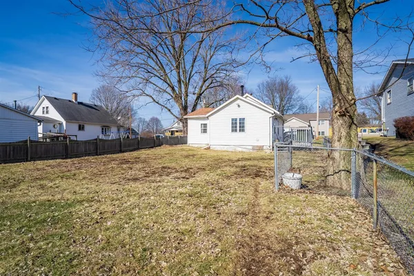 a front view of a house with a yard covered with snow
