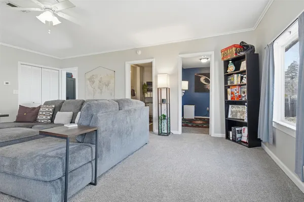 a living room with furniture and a book shelf
