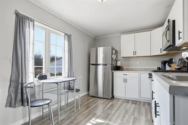a kitchen with stainless steel appliances granite countertop a refrigerator and a stove top oven