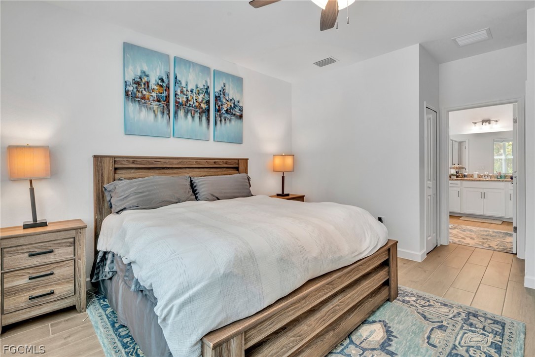 17388 Walnut Run Drive Alva, FL 33920 - Photo 18 of 24 a bedroom with a bed and a lamp on table