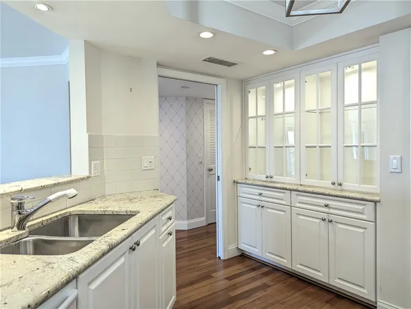 an empty room with a ceiling fan and carpet