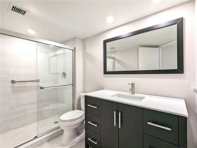 a bathroom with a sink toilet and shower