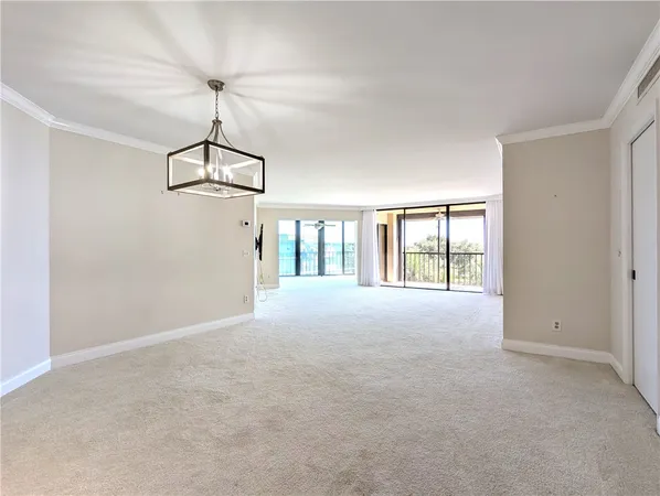 a view of a room with wooden floor and windows