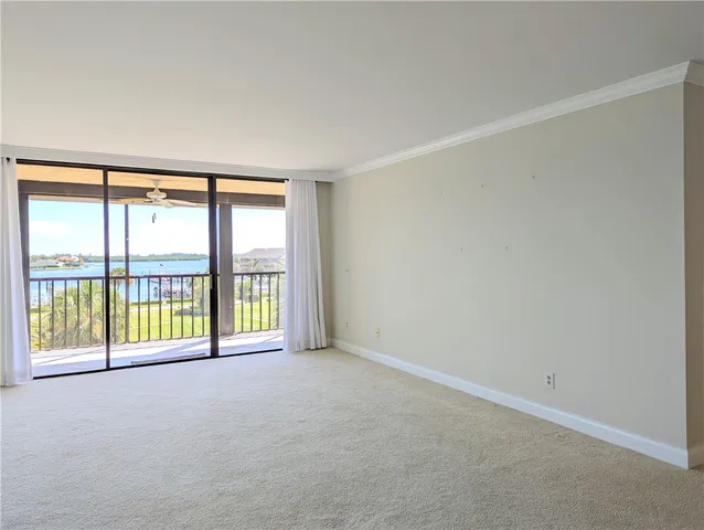 an empty room with large windows