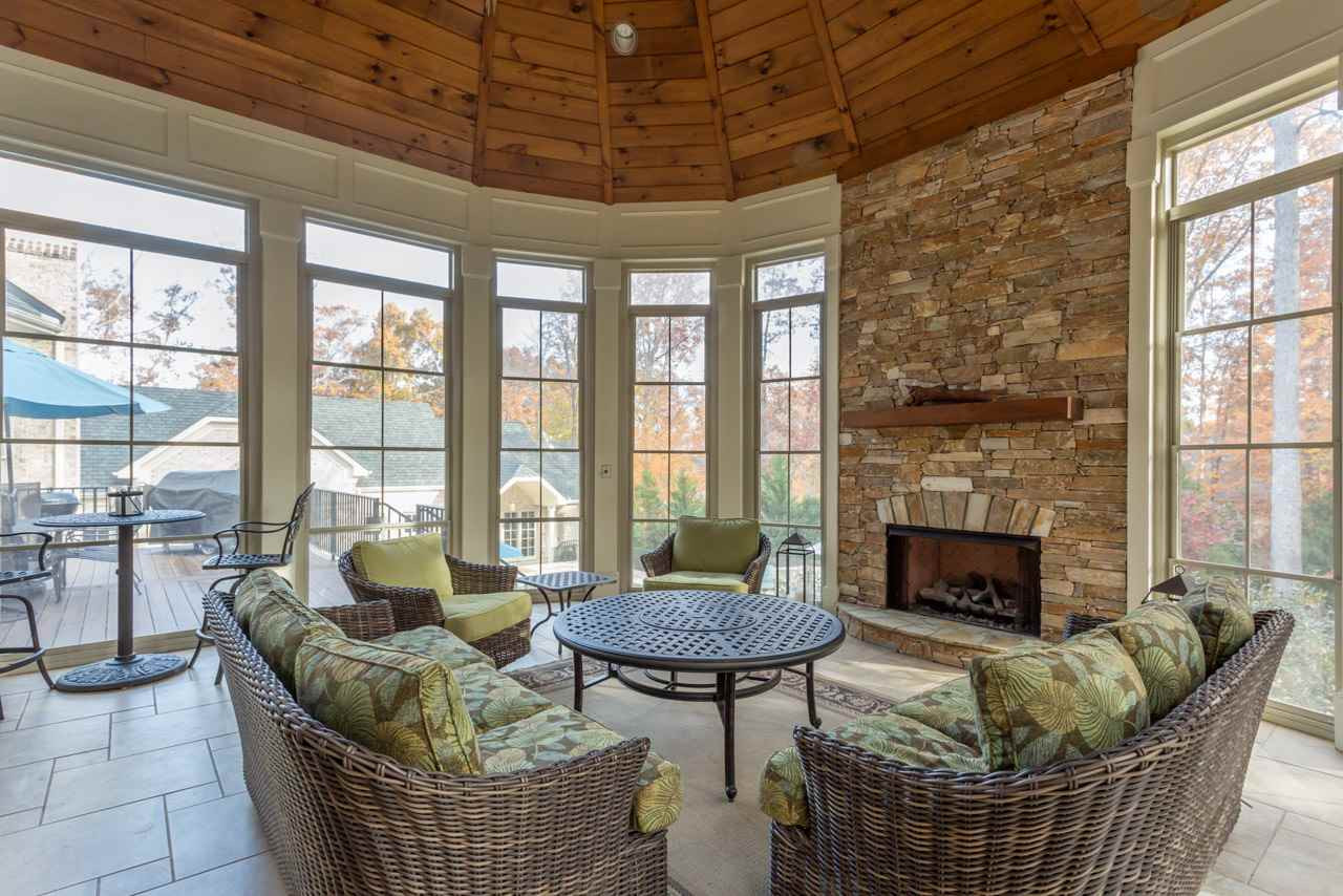 3032 Cone Manor Lane Raleigh, NC 27613 - Photo 11 of 30 The exceptional screen porch features a soaring tongue in groove wood ceiling, gas fireplace with stone surround, and desirable Easy Breeze Windows that lend this outdoor room to year round enjoyment and helps keep out pollen during the spring. Exceptional Screen Porch for all Seasons