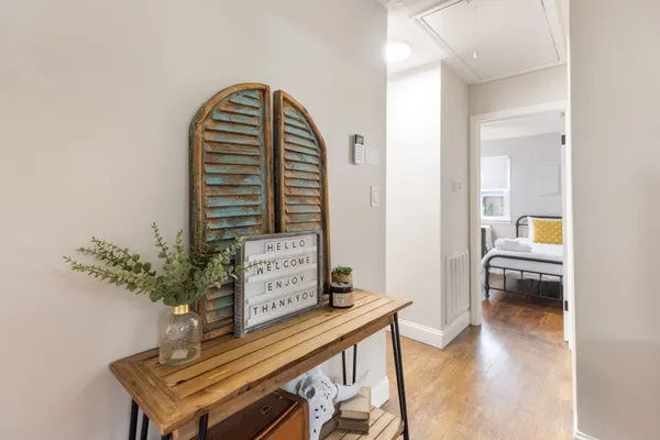 a view of hall way with furniture and wooden floor