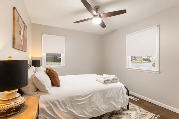 a bedroom with a bed and wooden floor