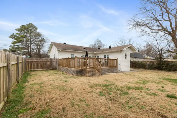 a view of a house with a yard covered in snow