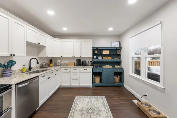 a kitchen with stainless steel appliances granite countertop refrigerator sink and stove
