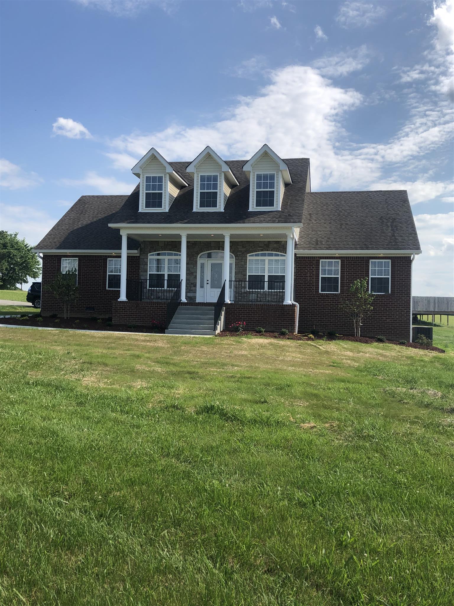 329 Piper Road Portland, TN 37148 - Photo 1 of 13 front view of a house with a garden