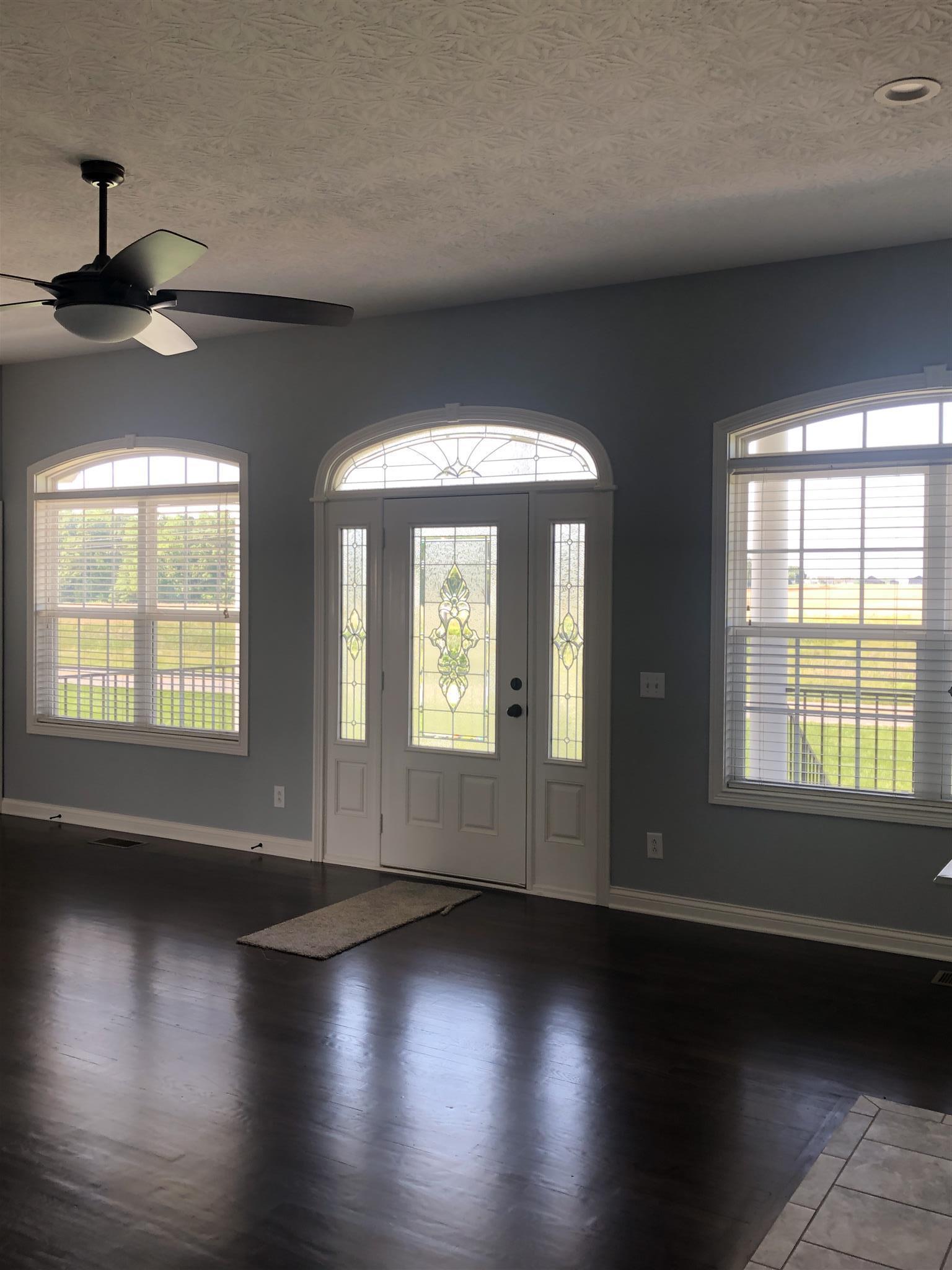 329 Piper Road Portland, TN 37148 - Photo 8 of 13 an empty room with wooden floor and windows