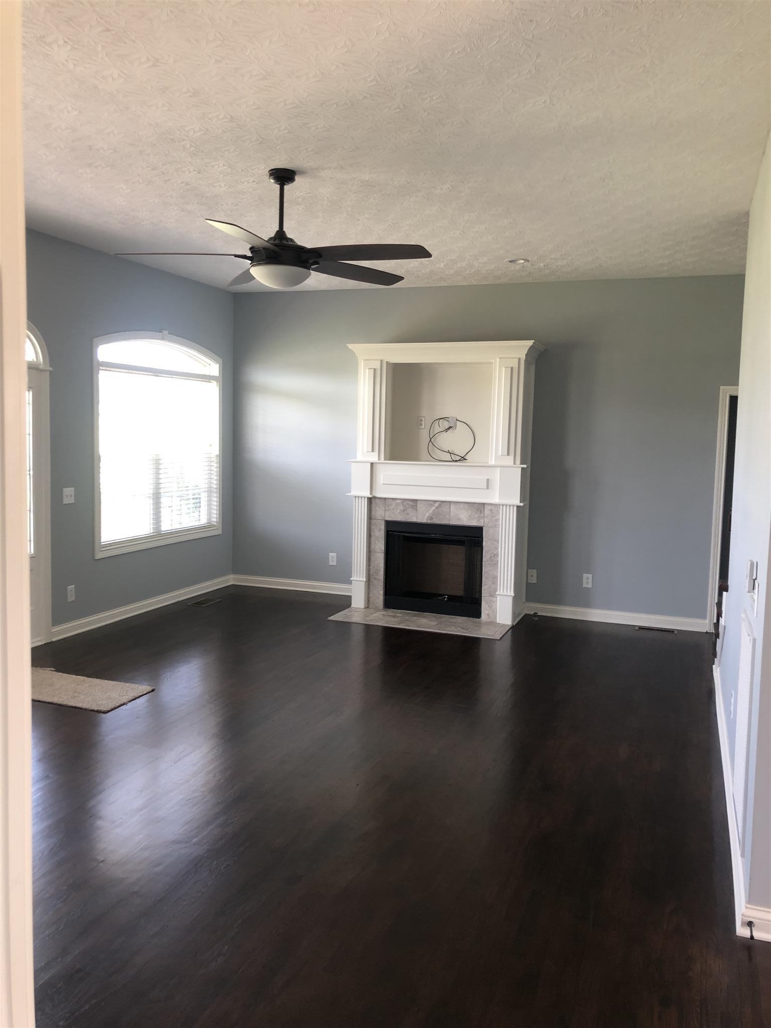 329 Piper Road Portland, TN 37148 - Photo 9 of 13 a view of empty room with wooden floor and fireplace