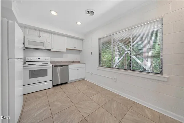 a kitchen with stainless steel appliances a stove sink and cabinets