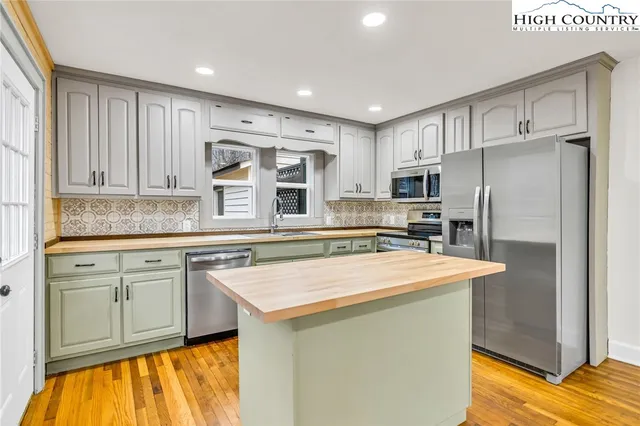 a kitchen with stainless steel appliances granite countertop a sink and a stove