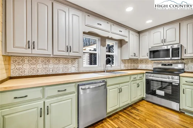 a view of a kitchen with windows and sink