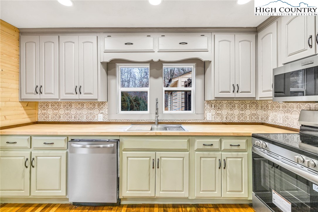 7 Legra Road Grassy Creek, NC 28631 - Photo 17 of 35 a kitchen with white cabinets and sink