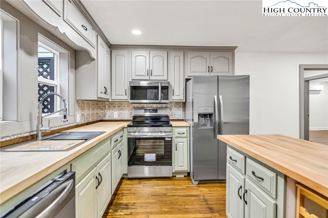 7 Legra Road Grassy Creek, NC 28631 - Photo 18 of 35 a kitchen with stainless steel appliances granite countertop a sink stove and refrigerator