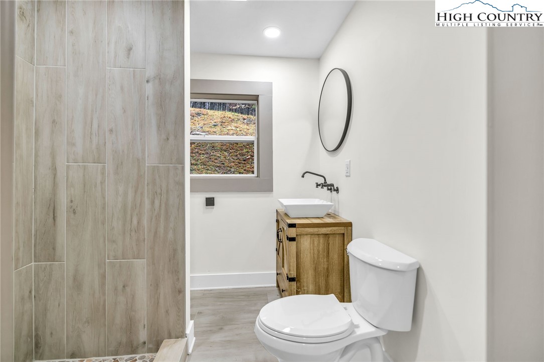 7 Legra Road Grassy Creek, NC 28631 - Photo 22 of 35 a white toilet sitting next to a bathroom sink