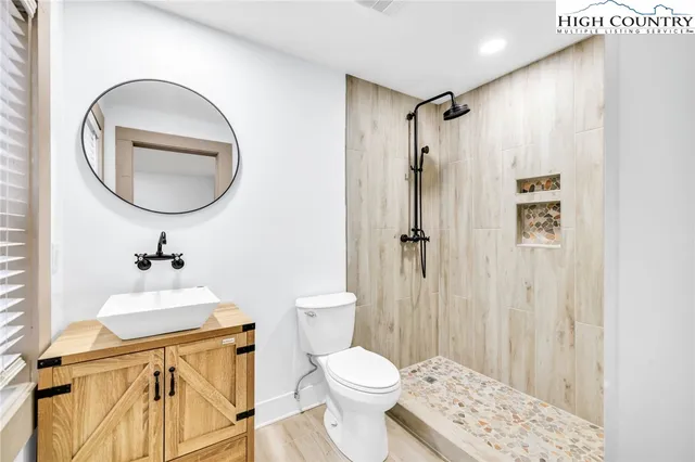 a bedroom with a bed and a wooden floor