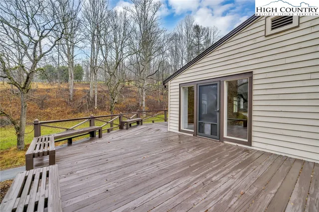 a view of balcony with wooden floor and fence