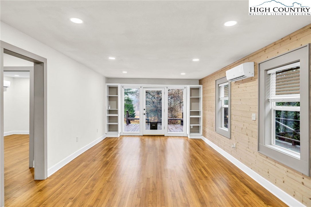 7 Legra Road Grassy Creek, NC 28631 - Photo 9 of 35 a view of an empty room with wooden floor and a window