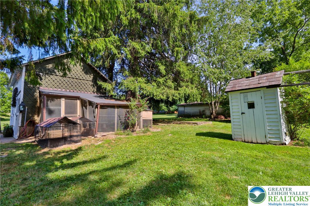 666 Point Phillips Road Bath, PA 18014 - Photo 58 of 68 A well-maintained yard provides ample space for outdoor activities, complemented by a charming shed and a screened-in porch.