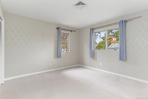 a bathroom with a granite countertop sink a mirror and a shower