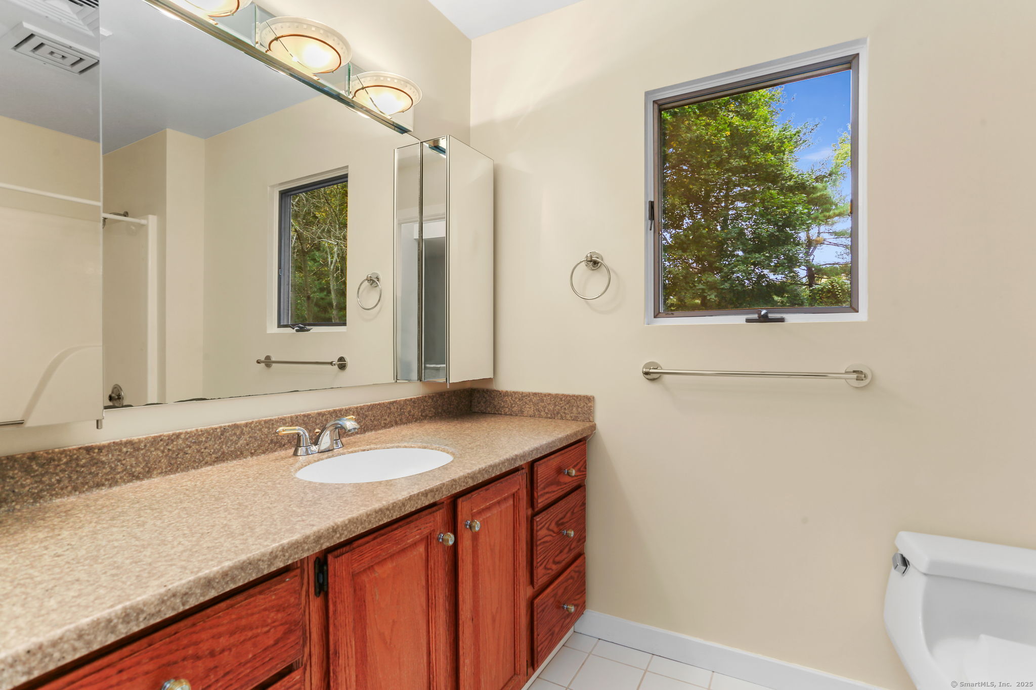 90 Sasco Hill Terrace Fairfield, CT 06824 - Photo 15 of 19 a bathroom with a granite countertop sink a mirror and a shower