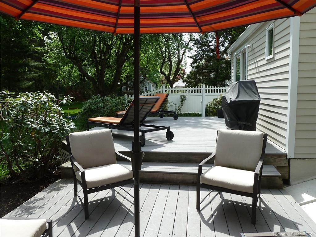 90 Sasco Hill Terrace Fairfield, CT 06824 - Photo 18 of 19 a view of a patio with a table chairs and a small yard