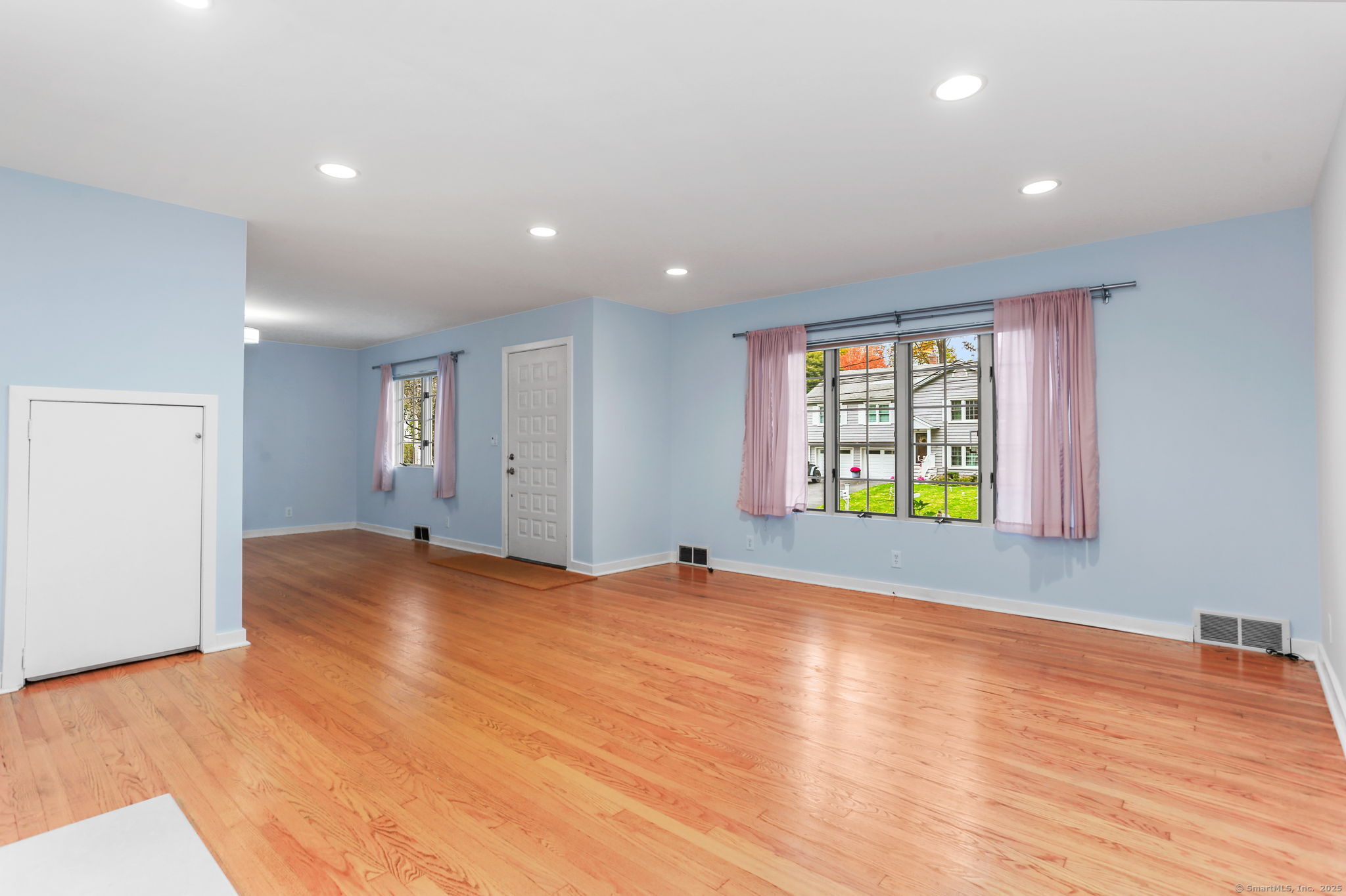 90 Sasco Hill Terrace Fairfield, CT 06824 - Photo 5 of 19 a view of an empty room with wooden floor and a window