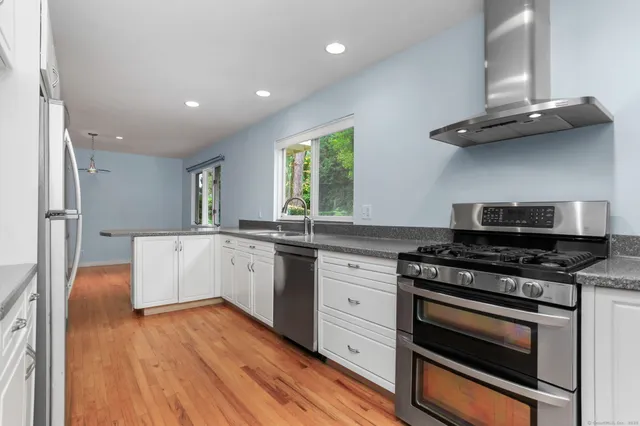 a kitchen with a stove a sink and a refrigerator