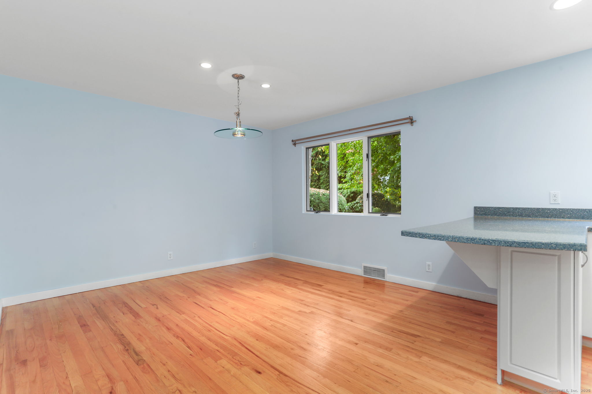 90 Sasco Hill Terrace Fairfield, CT 06824 - Photo 8 of 19 an empty room with wooden floor and windows