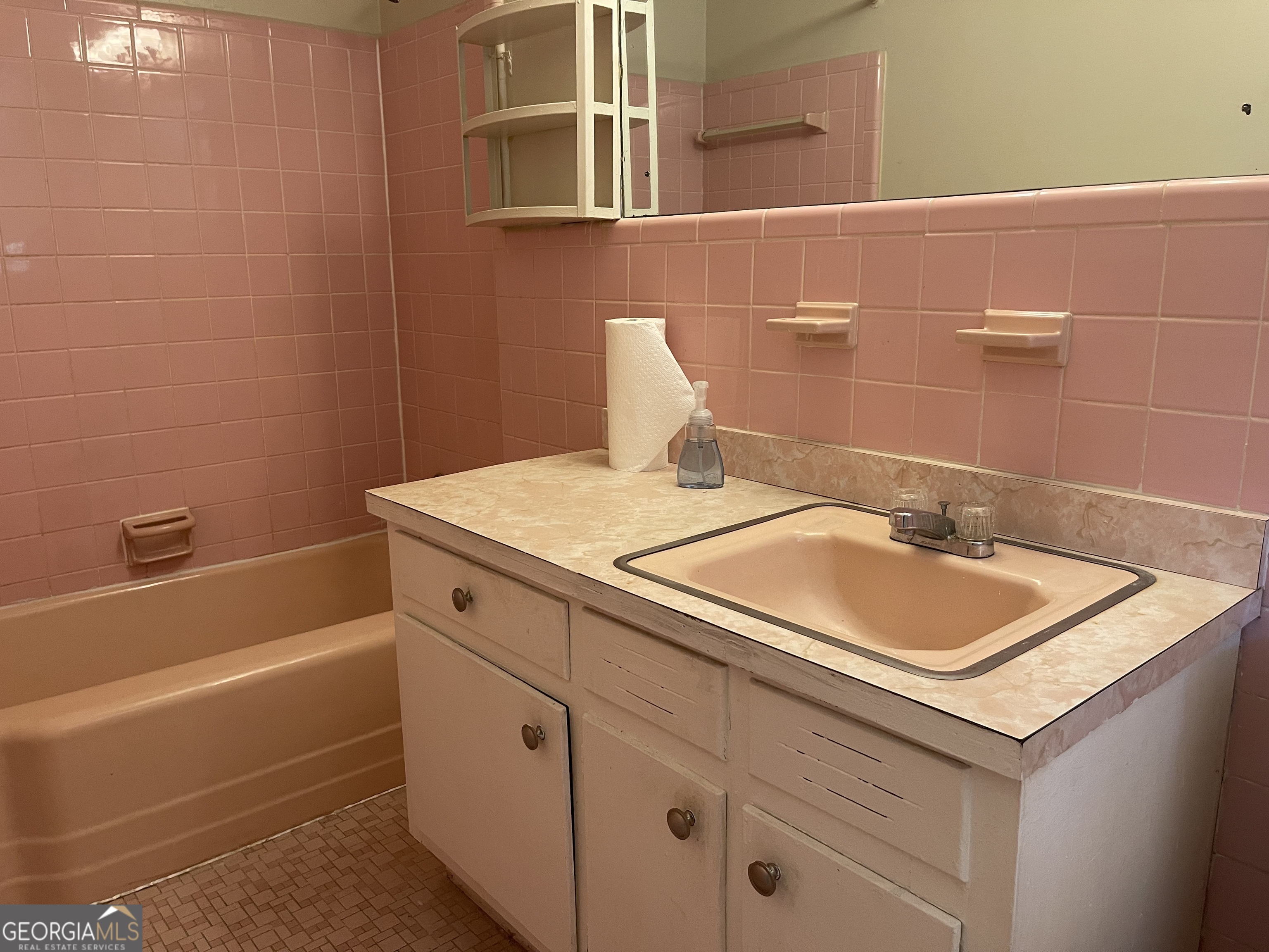 3027 Collier Drive Northwest Atlanta, GA 30318 - Photo 12 of 24 a bathroom with a sink and a bathtub