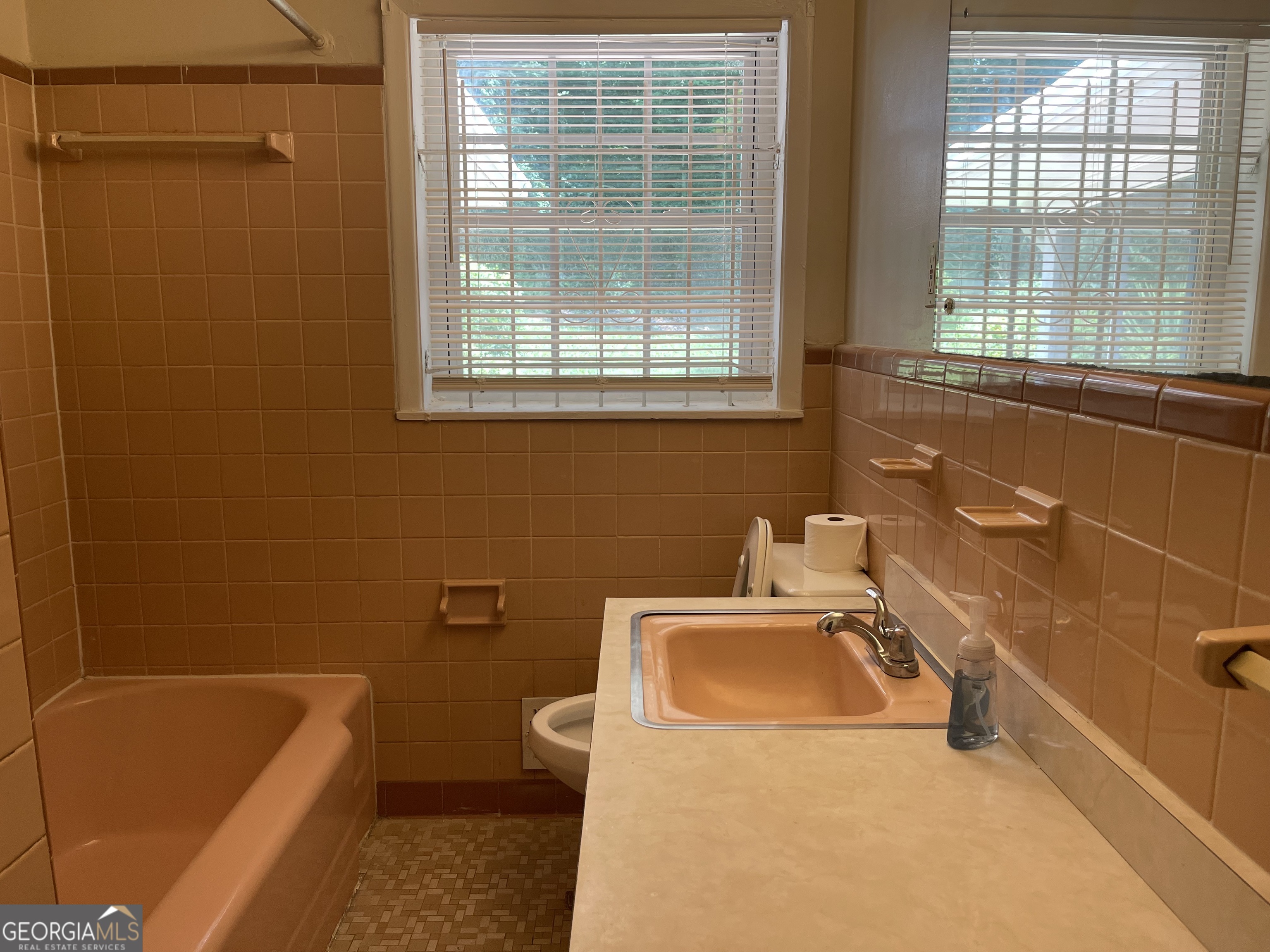 3027 Collier Drive Northwest Atlanta, GA 30318 - Photo 13 of 24 a bathroom with a sink a bathtub and window