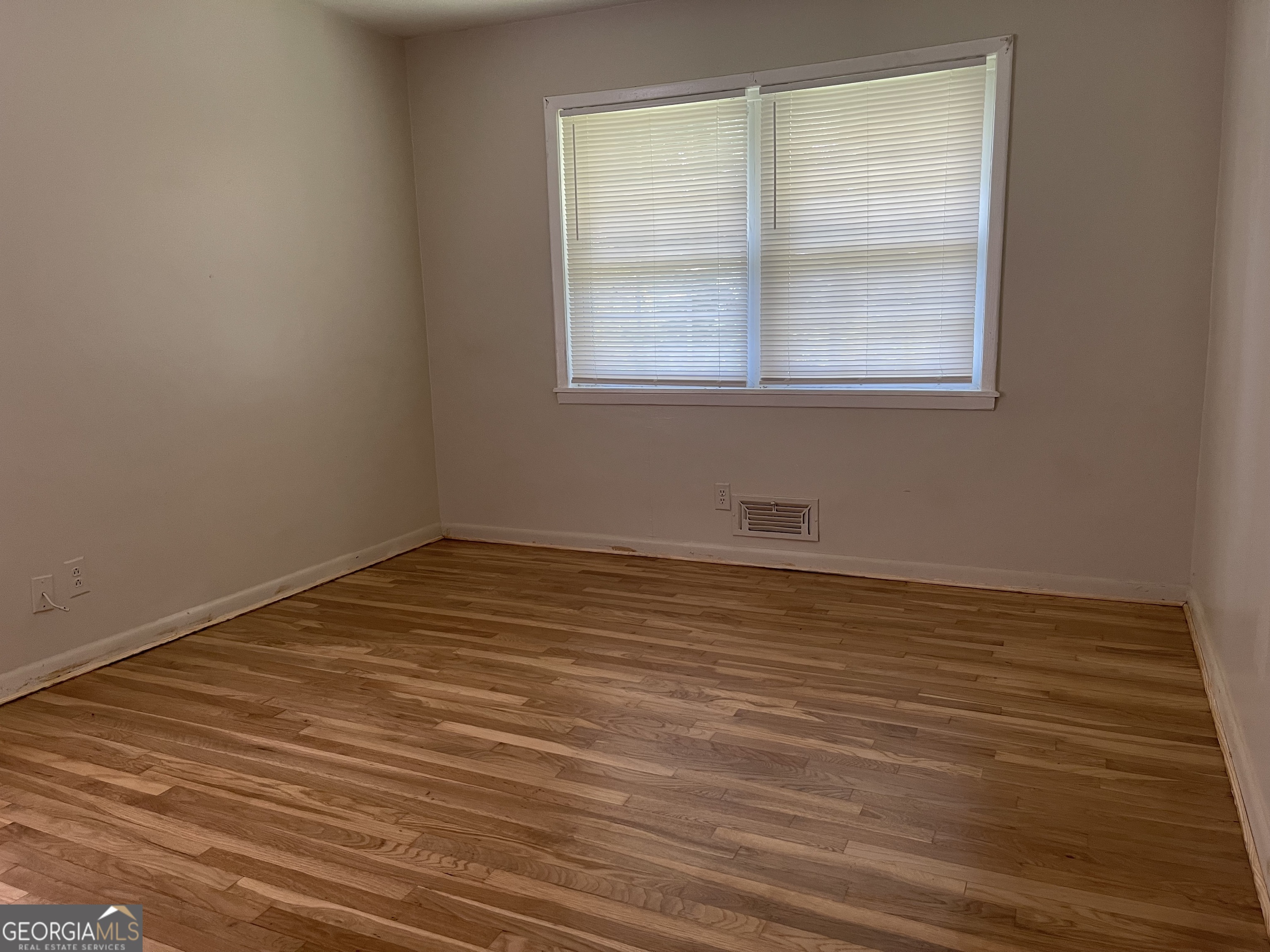 3027 Collier Drive Northwest Atlanta, GA 30318 - Photo 14 of 24 a view of a room with wooden floor and windows