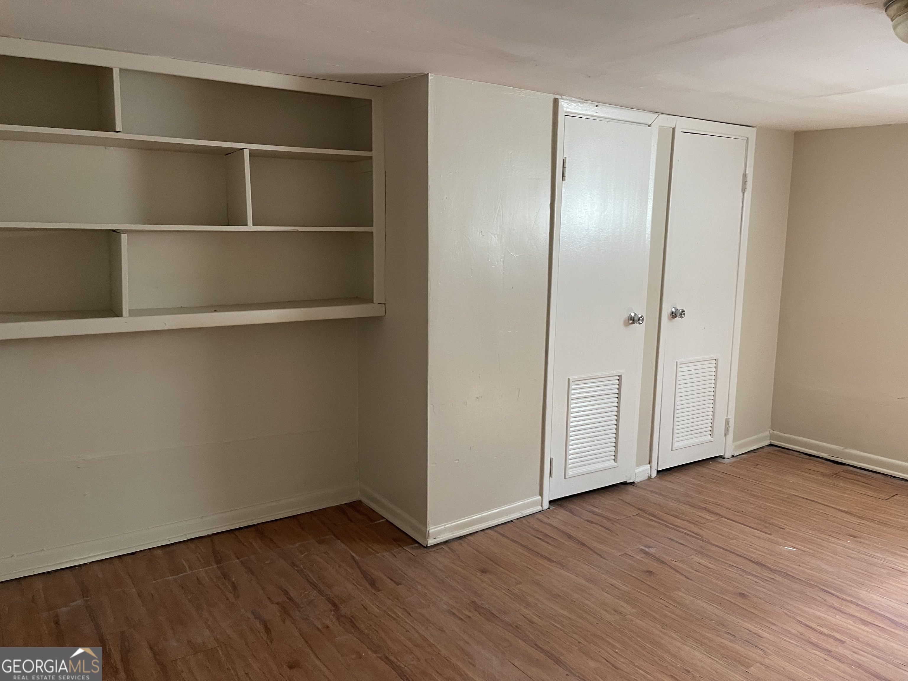 3027 Collier Drive Northwest Atlanta, GA 30318 - Photo 15 of 24 a view of an empty room with wooden floor and closet