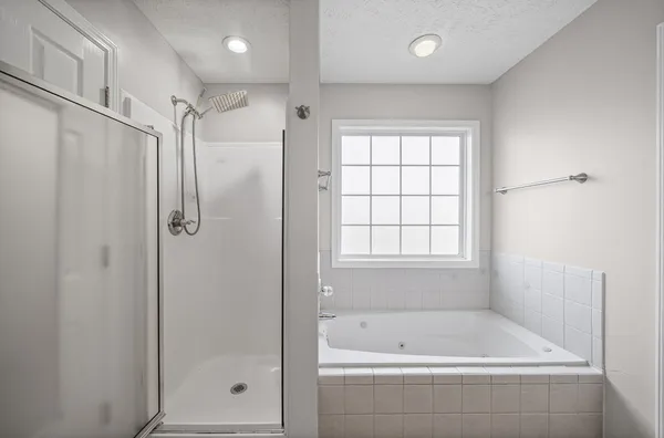 a bathroom with a bathtub and a shower