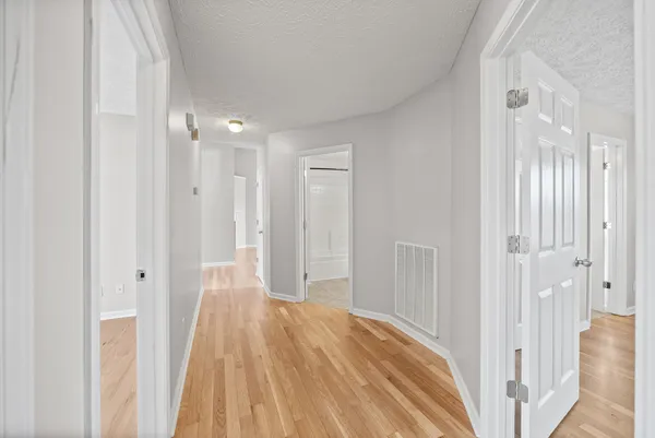 a view of a room with wooden floor